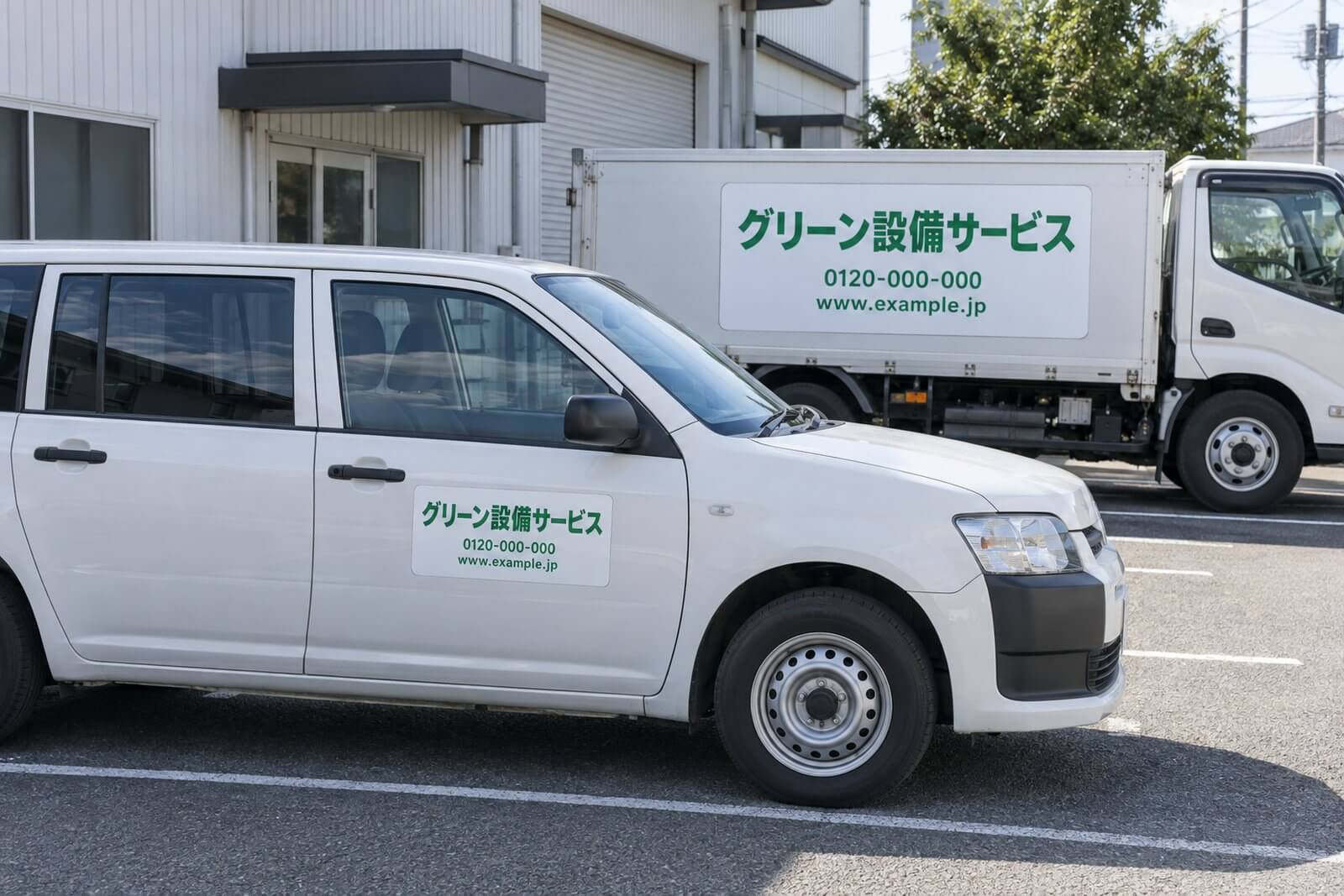 社名・電話番号・URLを入れたマグネット看板を運転席と助手席のドアに貼った白い営業車と、荷台側面に大きなマグネット看板を貼ったトラック