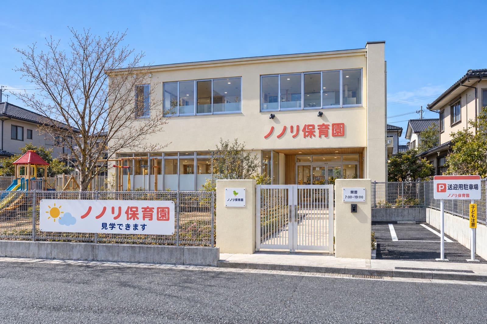園庭と駐車場のある新しい2階建ての保育園の外観。外壁に丸みのある立体文字の園名、道路側のフェンスにイラスト入りの園名の看板、門柱に園名のプレート、駐車場の入口に送迎用の駐車場の看板